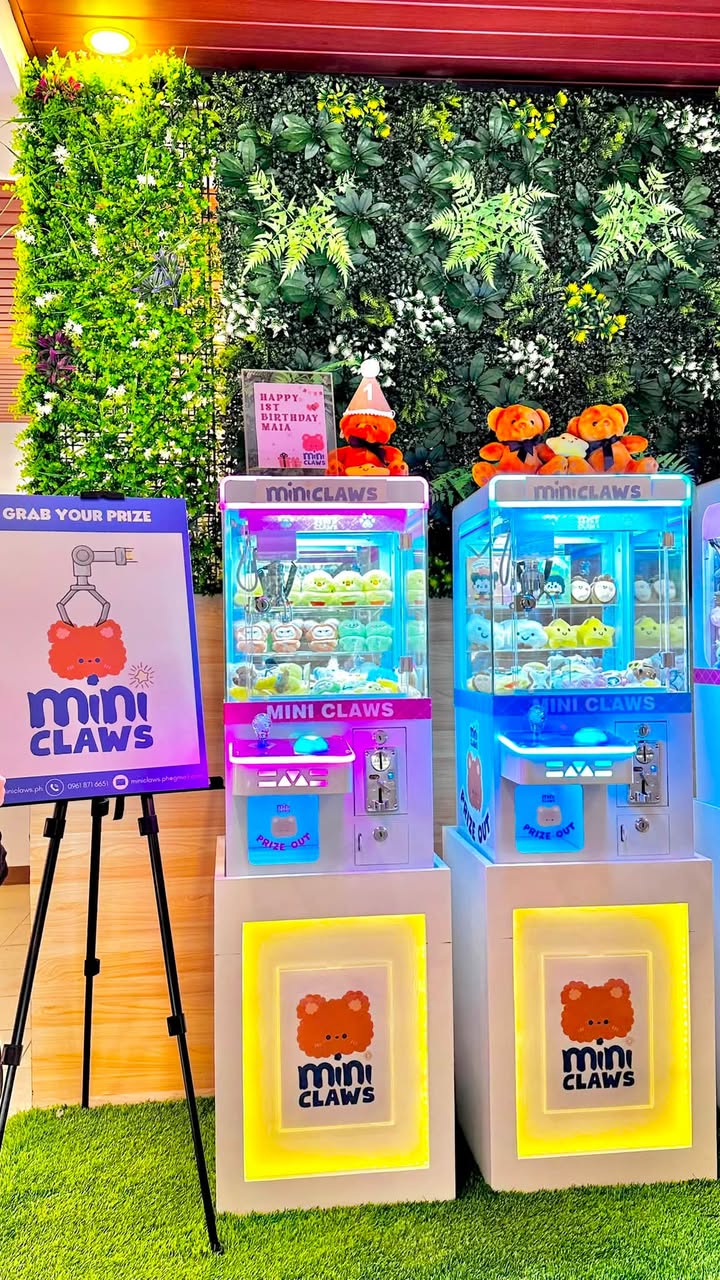 Two Mini Claws machines set up at an event